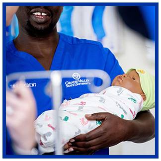 Nursing student with an infant manikin